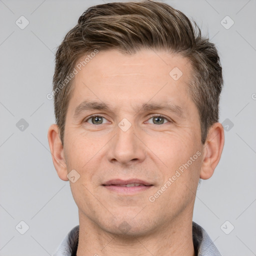 Joyful white adult male with short  brown hair and brown eyes