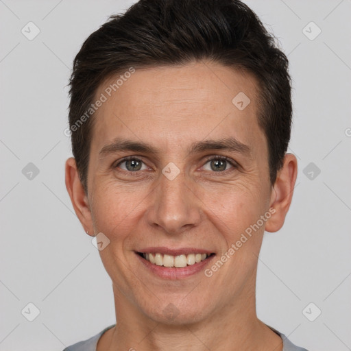 Joyful white adult male with short  brown hair and brown eyes