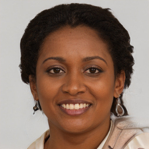 Joyful black young-adult female with medium  brown hair and brown eyes