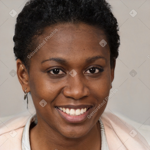 Joyful black young-adult female with short  brown hair and brown eyes