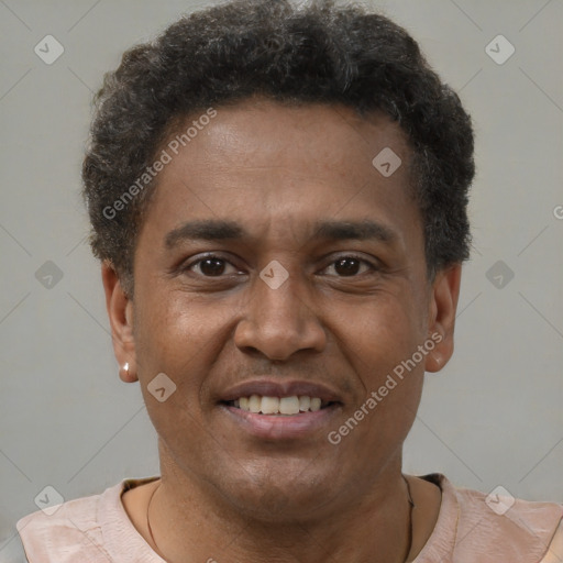Joyful latino young-adult male with short  brown hair and brown eyes