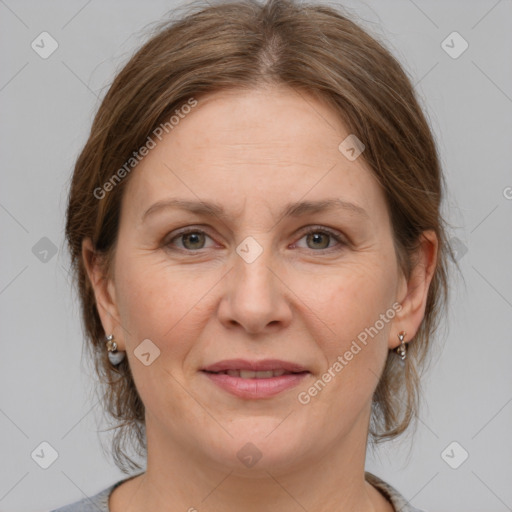 Joyful white adult female with medium  brown hair and grey eyes