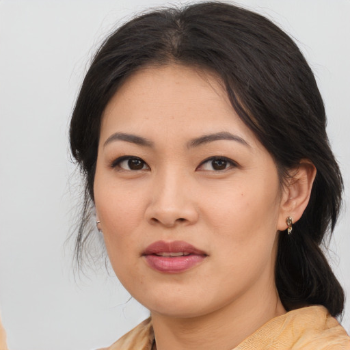 Joyful asian young-adult female with medium  brown hair and brown eyes
