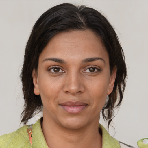 Joyful black young-adult female with medium  brown hair and brown eyes