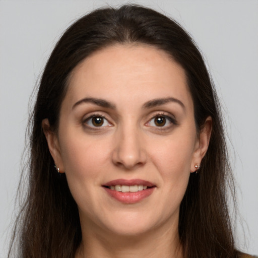 Joyful white young-adult female with long  brown hair and grey eyes