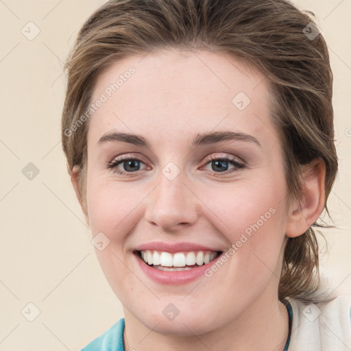 Joyful white young-adult female with medium  brown hair and green eyes