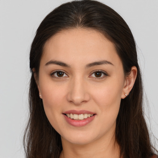 Joyful white young-adult female with long  brown hair and brown eyes