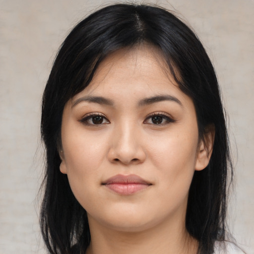 Joyful asian young-adult female with long  black hair and brown eyes