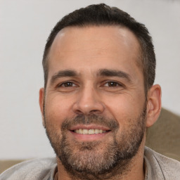 Joyful white adult male with short  brown hair and brown eyes