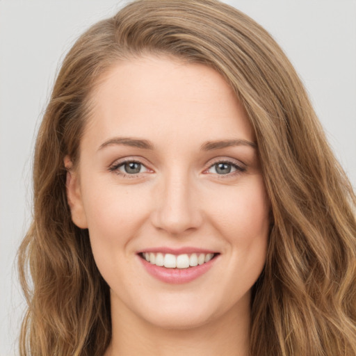 Joyful white young-adult female with long  brown hair and green eyes