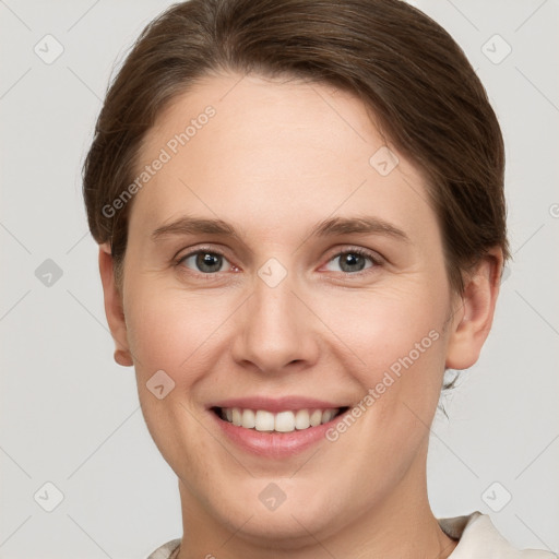 Joyful white young-adult female with short  brown hair and grey eyes