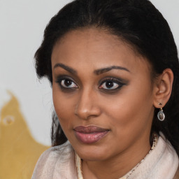 Joyful black young-adult female with medium  brown hair and brown eyes