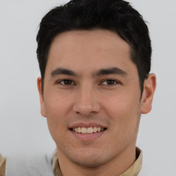 Joyful asian young-adult male with short  brown hair and brown eyes