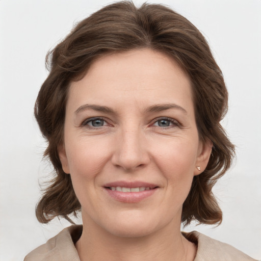 Joyful white young-adult female with medium  brown hair and grey eyes