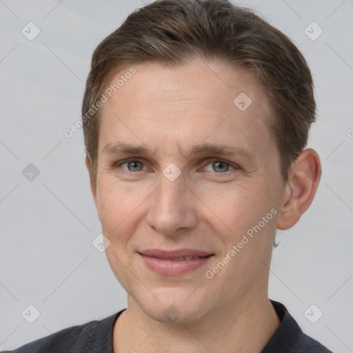 Joyful white adult male with short  brown hair and grey eyes