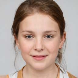 Joyful white child female with medium  brown hair and brown eyes