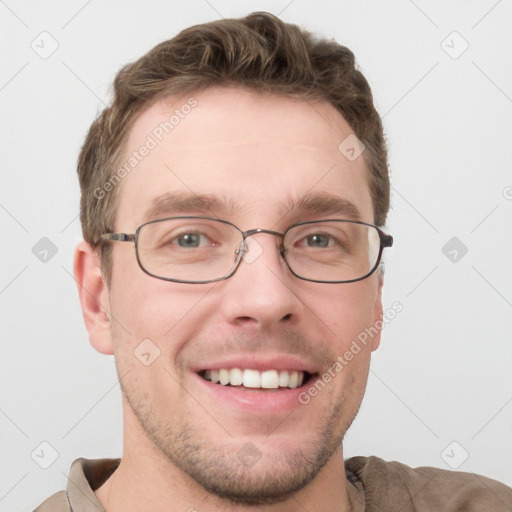 Joyful white young-adult male with short  brown hair and grey eyes