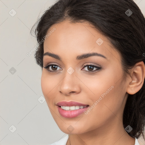 Joyful latino young-adult female with long  brown hair and brown eyes