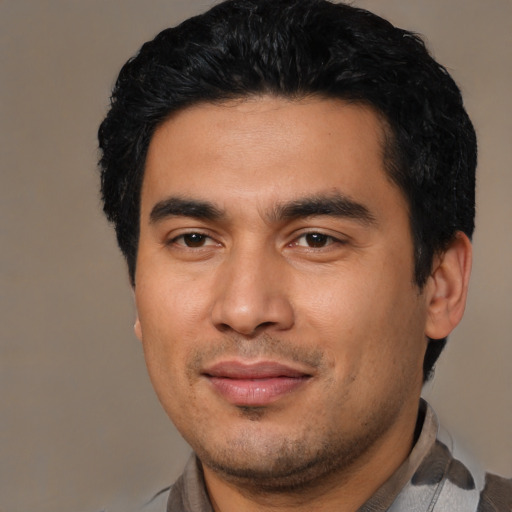 Joyful latino young-adult male with short  black hair and brown eyes