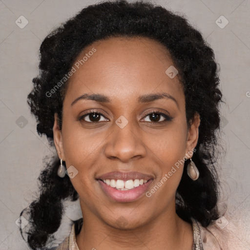 Joyful black young-adult female with long  black hair and brown eyes