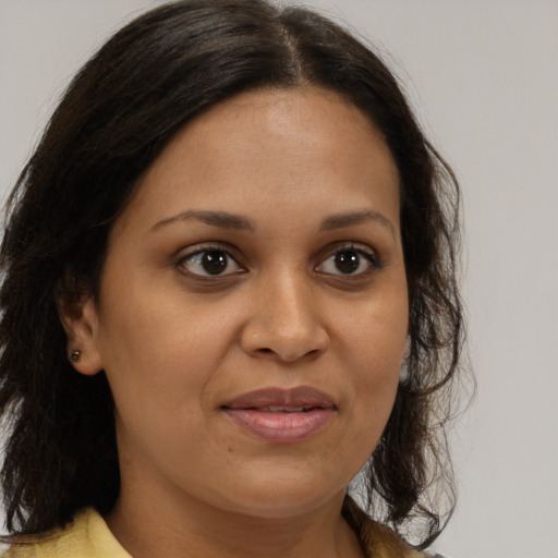 Joyful black young-adult female with medium  brown hair and brown eyes
