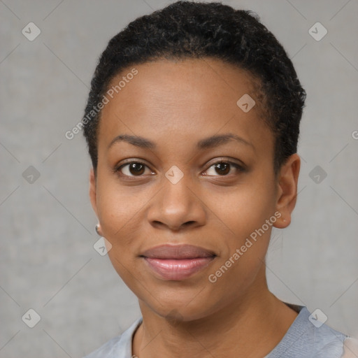 Joyful black young-adult female with short  black hair and brown eyes