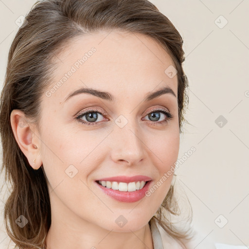 Joyful white young-adult female with long  brown hair and blue eyes