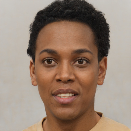 Joyful black young-adult female with short  black hair and brown eyes