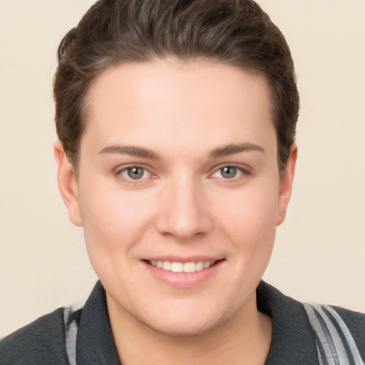 Joyful white young-adult female with short  brown hair and grey eyes