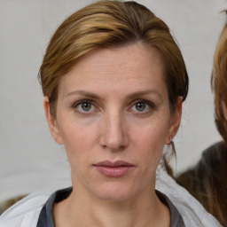 Joyful white young-adult female with medium  brown hair and blue eyes