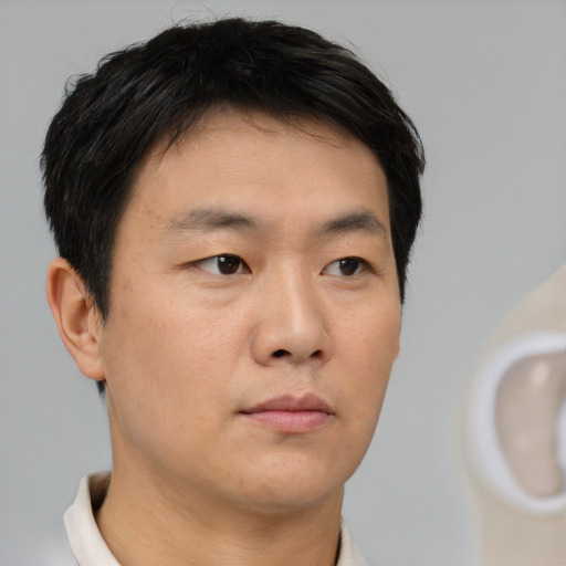 Neutral asian young-adult male with short  brown hair and brown eyes