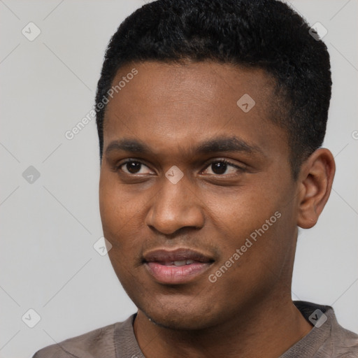 Joyful black young-adult male with short  black hair and brown eyes