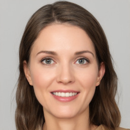 Joyful white young-adult female with medium  brown hair and green eyes