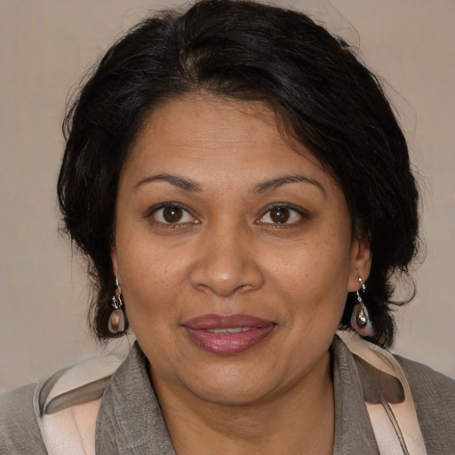 Joyful black adult female with medium  brown hair and brown eyes