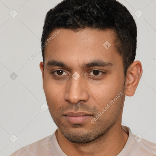 Neutral latino young-adult male with short  black hair and brown eyes