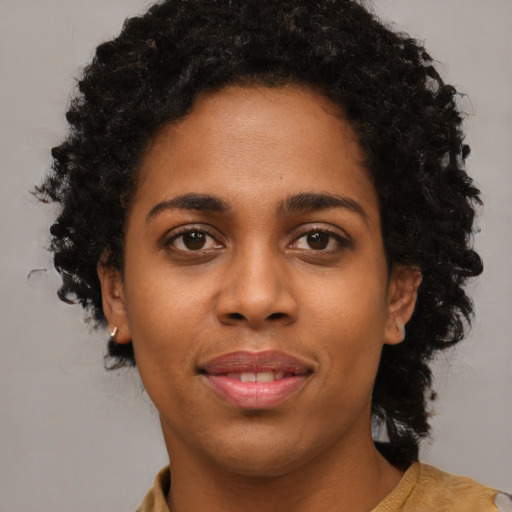 Joyful black young-adult female with medium  black hair and brown eyes
