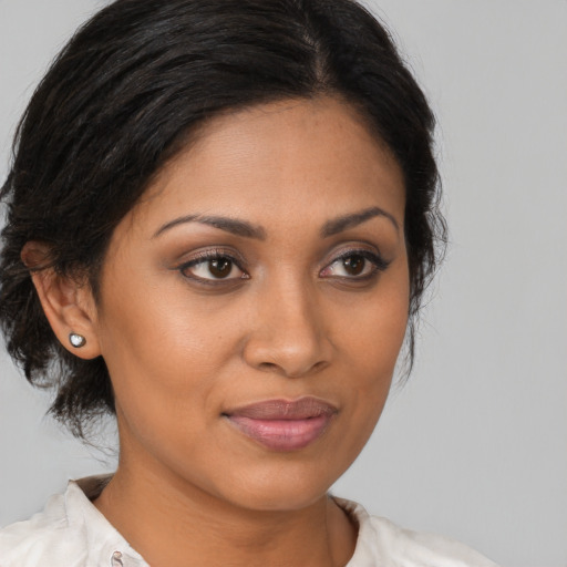 Joyful black young-adult female with medium  brown hair and brown eyes
