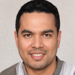 Joyful white young-adult male with short  black hair and brown eyes