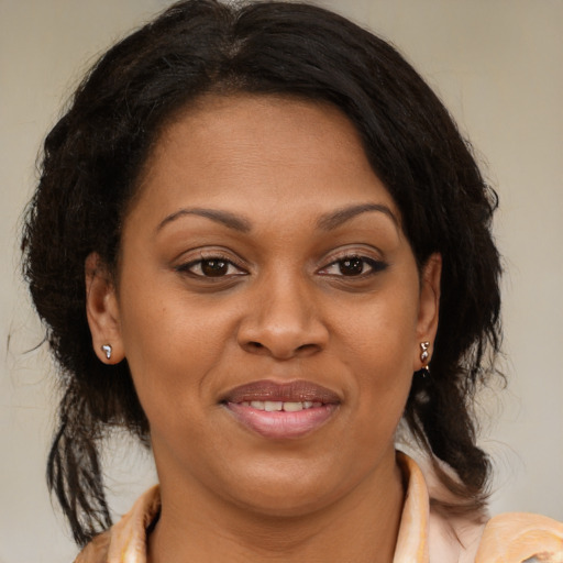 Joyful latino adult female with medium  brown hair and brown eyes