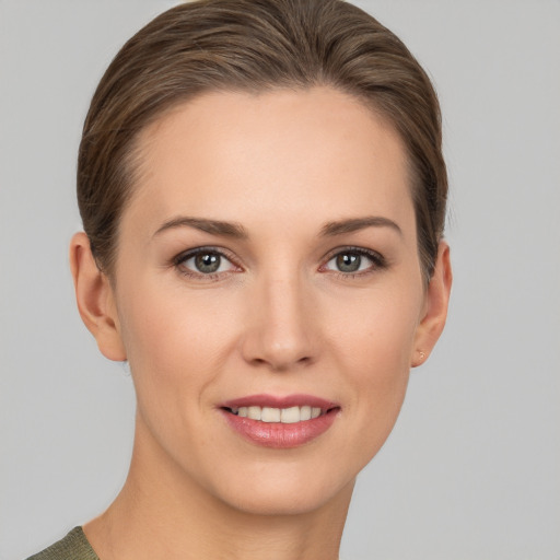 Joyful white young-adult female with medium  brown hair and grey eyes