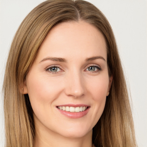 Joyful white young-adult female with long  brown hair and brown eyes