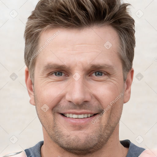 Joyful white adult male with short  brown hair and grey eyes