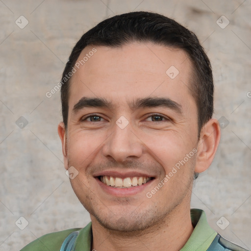 Joyful white young-adult male with short  black hair and brown eyes