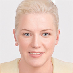 Joyful white young-adult female with short  blond hair and blue eyes