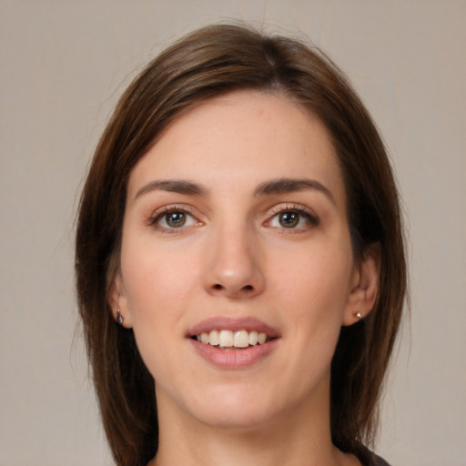 Joyful white young-adult female with medium  brown hair and brown eyes