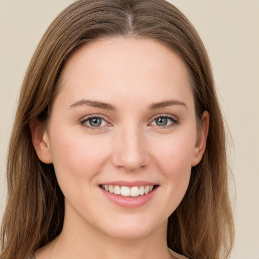 Joyful white young-adult female with long  brown hair and grey eyes