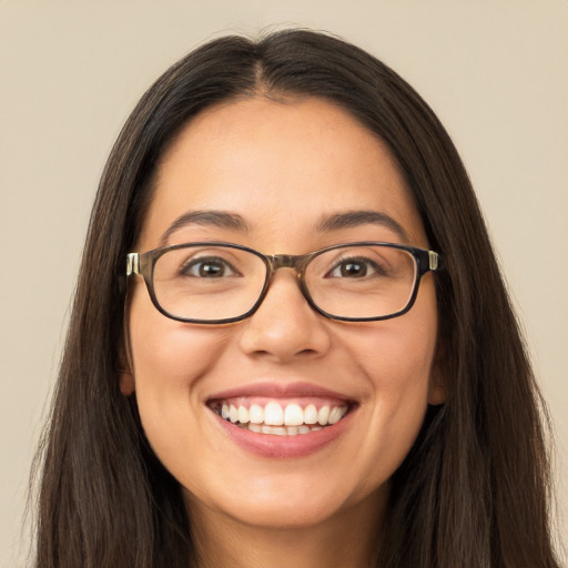 Joyful white young-adult female with long  brown hair and brown eyes