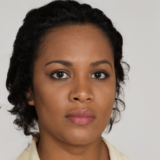 Neutral black young-adult female with medium  brown hair and brown eyes