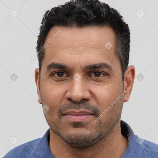 Joyful white adult male with short  black hair and brown eyes