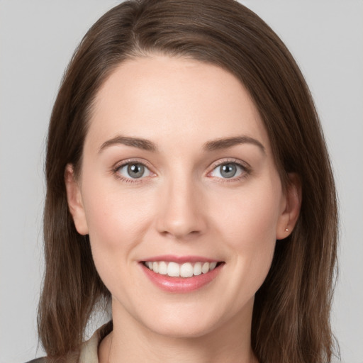 Joyful white young-adult female with long  brown hair and grey eyes